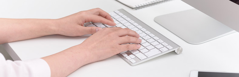 hands typing on a keyboard