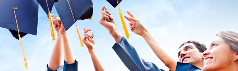 Graduates throwing caps in the air