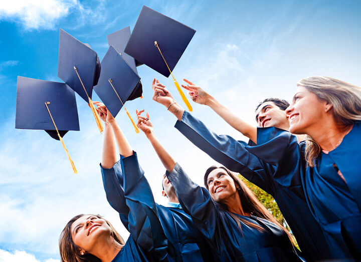 graduates throwing their caps in the air